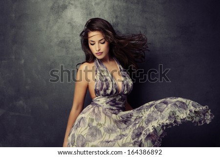 beautiful young  woman in an elegant dress studio shot