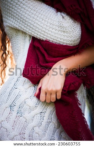 woman  wearing white wool dress, red wool  scarf  outdoor shot in autumn park