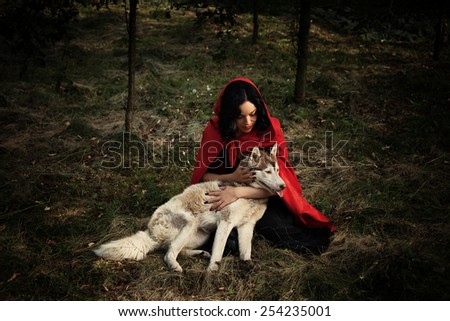 red riding hood and the wolf outdoor in the wood
