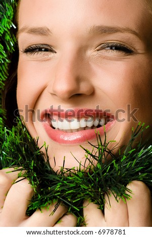 young woman framed with green garland, studio shot,