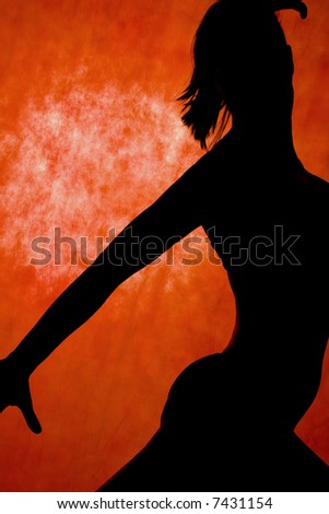 woman dance, silhouette in front of orange background