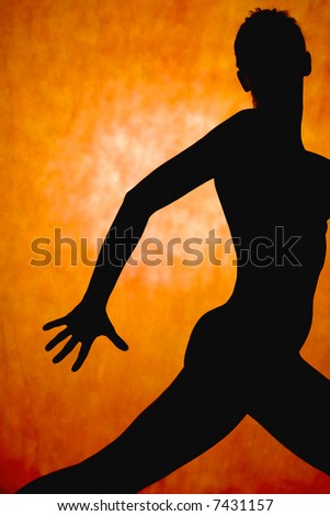 woman dance, silhouette in front of orange background