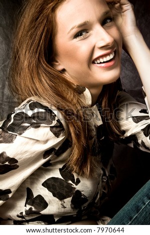 young and happy woman portrait, studio dark background