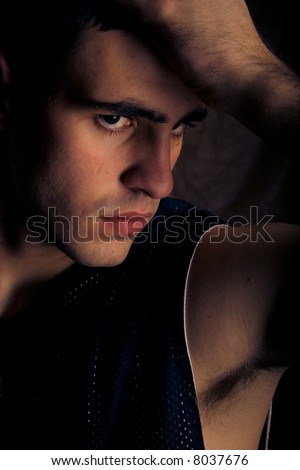 young man profile on dark background