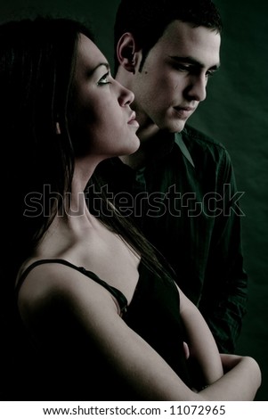 young couple, dark background , studio