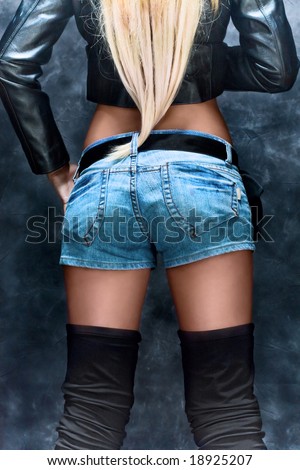 woman with long blond hair in jeans shorts from behind