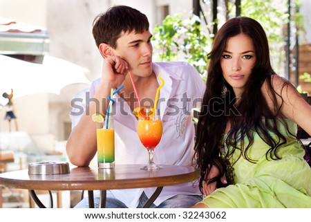 young couple in restaurant, outdoor, summer day