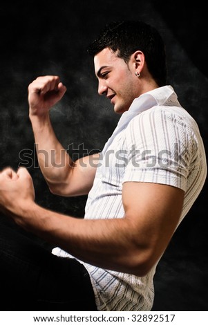 young strong happy man in motion, studio shot