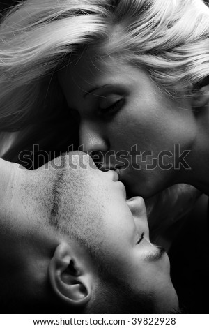 sensual couple kissing, close up, studio, black and white