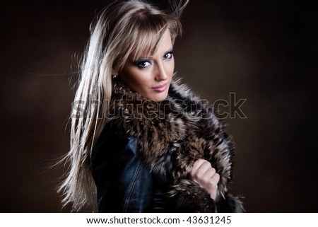 beautiful blond in leather jacket with fur portrait