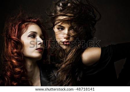 red hair and brunette woman portrait, studio shot