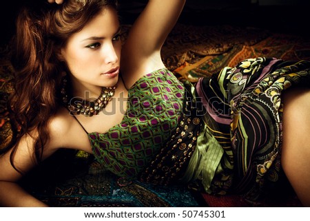 beautiful brunette woman in oriental style clothes, studio shot