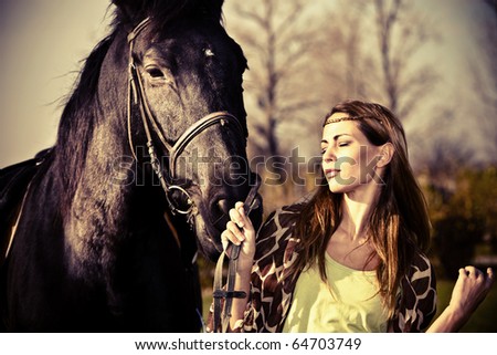 young woman walking with horse