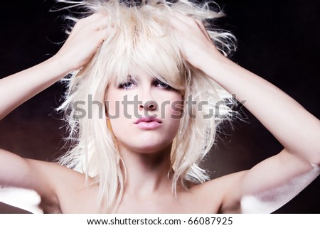 blond woman with hands in hair