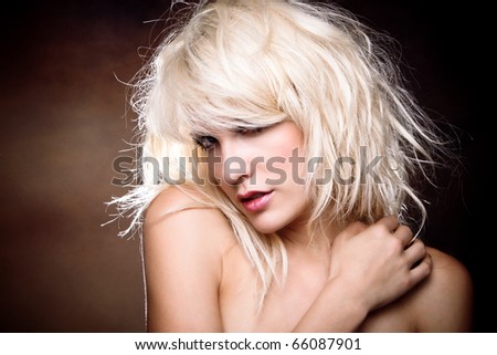 sensual blond woman studio portrait, dark background