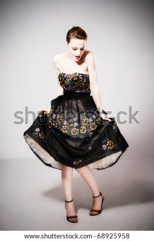 young woman in elegant high fashion dress, studio shot, full body shot