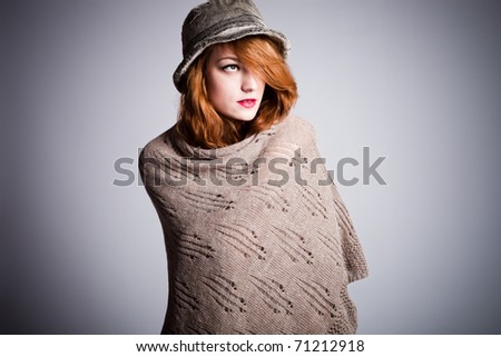 young red hair woman in winter clothes portrait in studio