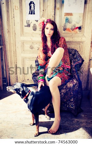 young woman in colorful clothes play with dog, indoor shot,