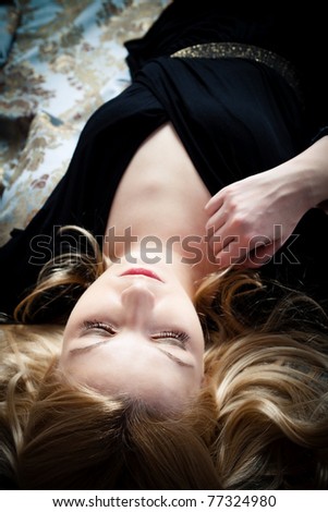 sensual blond woman lie down, studio shot