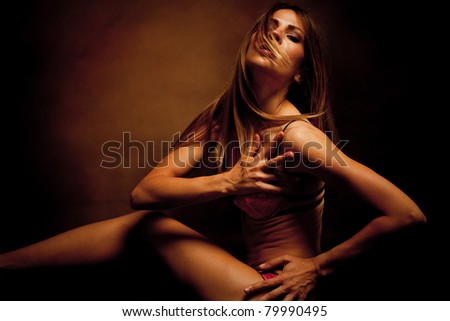 sensual woman in underwear studio shot dark background