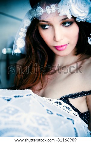 beautiful young woman with headband and parasol, indoor shot