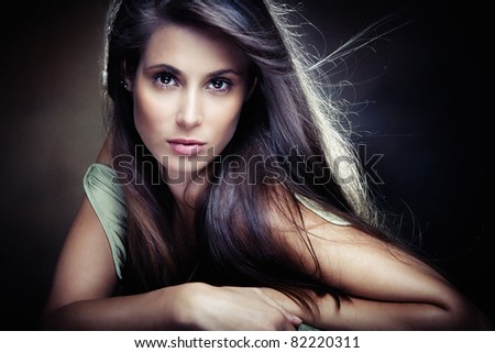 beautiful long hair brunette woman,  small amount of grain added, studio shot