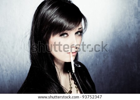 black hair woman in leather jacket, smoking, studio shot