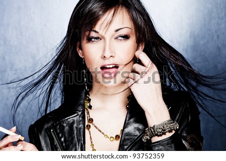 black hair woman in leather jacket, studio shot