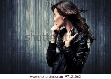 melancholy adult woman in black leather  jacket profile portrait