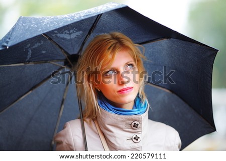 the girl with a black umbrella costs in the rain