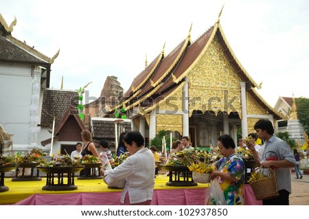 CHIANG MAI THAILAND-MAY 19 : Inthakhin traditional Offerings of flowers.Thai people offering flowers incense candles attended a ceremony to worship the city pillar.on May 19,2012 in Chiangmai Thailand