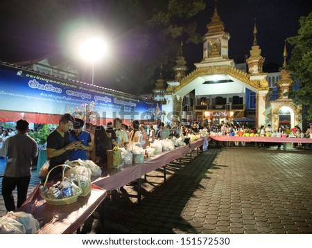 CHIANG MAI THAILAND-AUGUST 20 : Night give food offerings.People attending the Night offering alms to adopted the traditions come together. Annual basis at .on August 20,2013 in Chiangmai,Thailand.