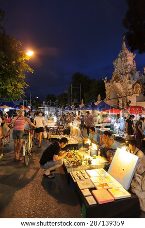 CHIANG MAI THAILAND - JUNE 14 : Sunday market walking street, The city center Thai temple marketing and trading of local tourists come to buy souvenirs. on June 14, 2015 in Chiang Mai, Thailand.