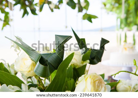 Floral arrangement at a wedding ceremony on the beach.