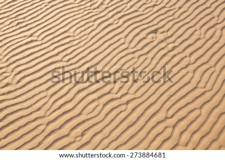 closeup of sand pattern of a beach in the summer/sand texture