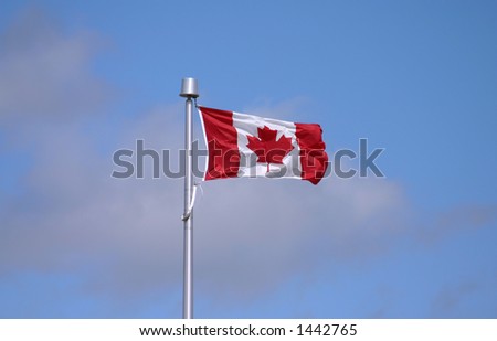 Canadian Flag blowing against blue sky