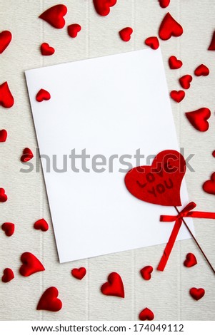 Empty postcard with fabric heart that says Love You and a lot of