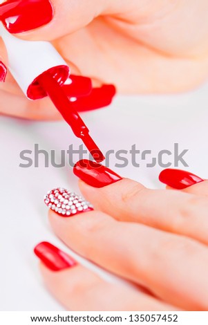 polish on fingers with red nails