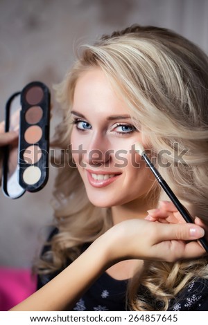 Woman with makeup brush. Stylist. make up brush