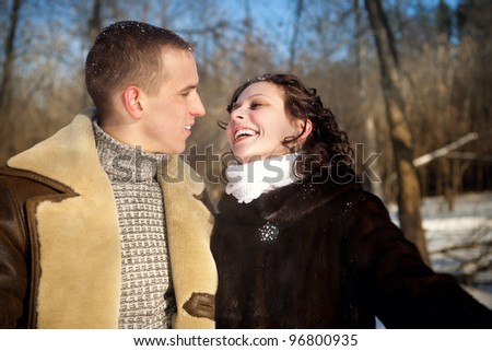 A young couple in the winter forest