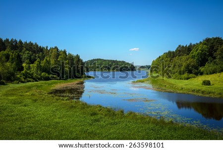 blue calm river in the forests and fields
