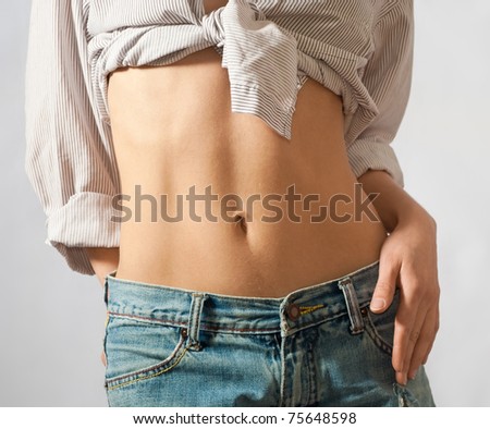 slim waist of girl in jeans and chemise