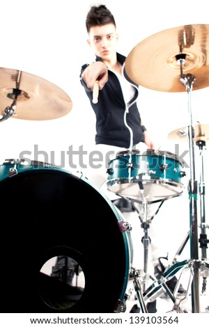 Drummer holding his drum stick in focus near drum set