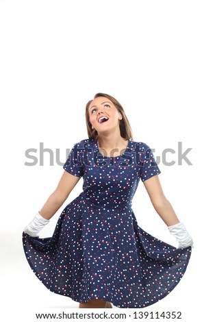Stylish woman wearing polka dots dress and feeling good and dancing in the studio