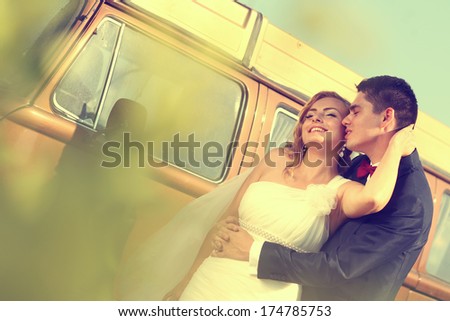 Bride and groom with a retro bus