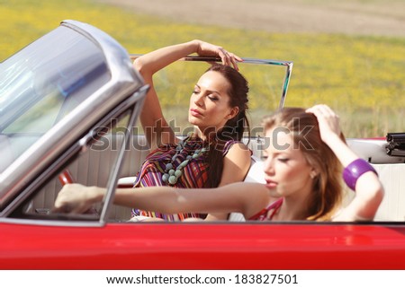 Beautiful women driving a red car wearing accesoriess