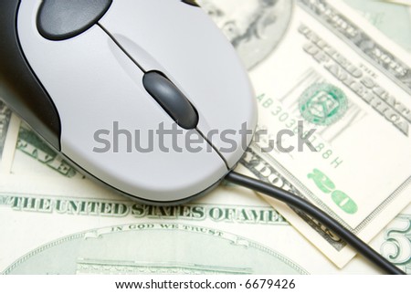 Money spend over internet, computer mouse over dollar bills