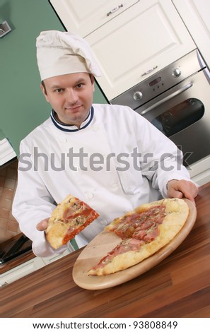 Pizza chef holding slice of pizza and smiling at you