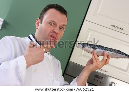 What the hell is this? Chef pointing with finger on to fish with question face expression.