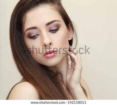 Beautiful makeup woman face looking down. Closeup portrait